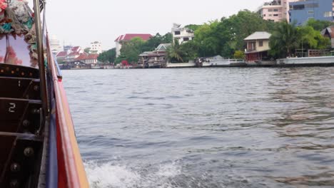 A-nice-shot-of-the-waves-of-a-longtail-boat-sailing-on-the-river-of-Bangkok,-the-capital-of-Thailand