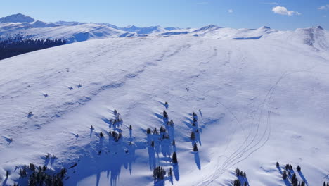 Two-backcountry-skiers-Ptarmigan-Hill-Vail-Pass-Colorado-aerial-drone-Rocky-Mountains-landscape-sunny-bluebird-sky-cold-winter-morning-i70-deep-powder-snowboarding-skier-snowmobile-backcountry-forward