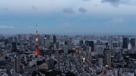 beautiful 4k timelapse over tokyo cityscape at dusk illumination lighting up tokyo tower - zoom in