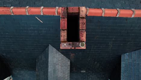 top view of brick chimney hole on the roof of a residential house