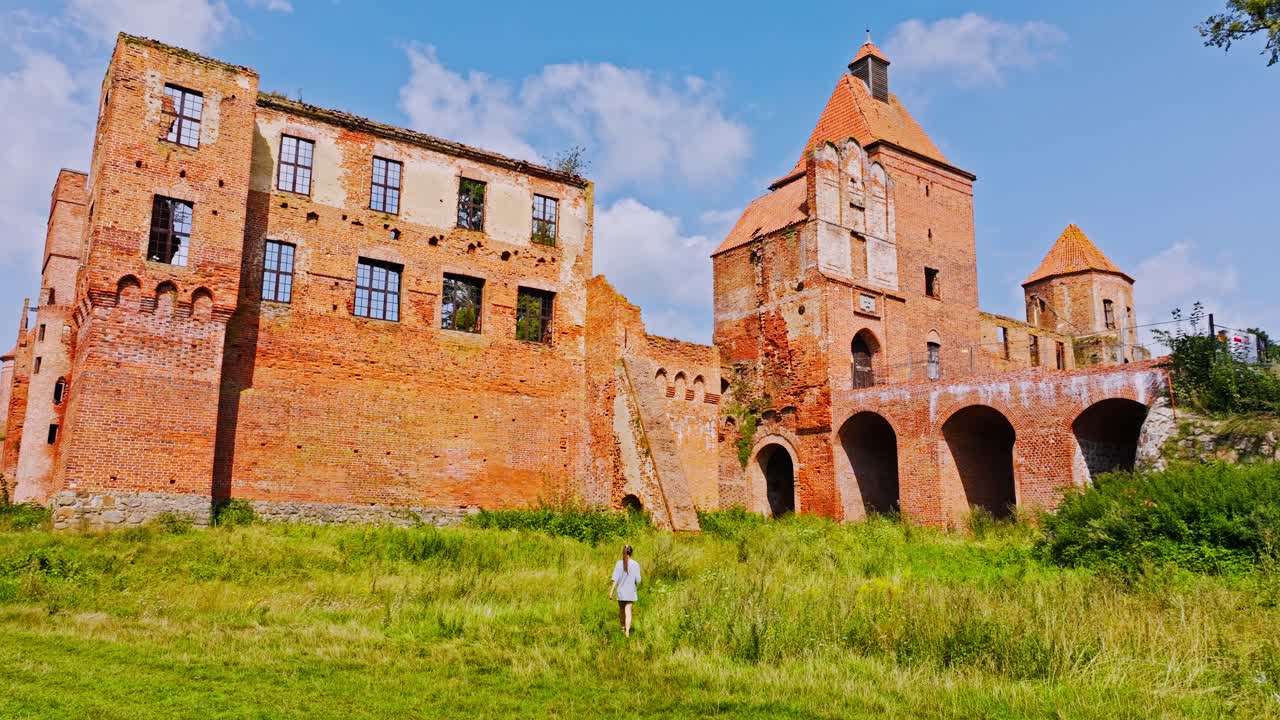 Hero frame of traveler exploring historic Pomezania Szymbark Castle ruins