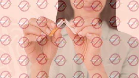animación de filas de cigarrillos encendidos sin señales de fumar sobre una mujer biracial rompiendo un cigarrillo
