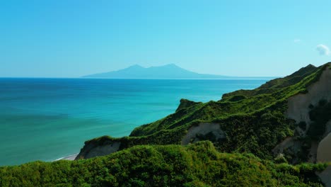 coastal view with lush vegetation and volcano in the distance