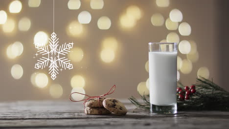 animación de decoraciones navideñas de copos de nieve, galletas y un vaso de leche sobre un fondo gris