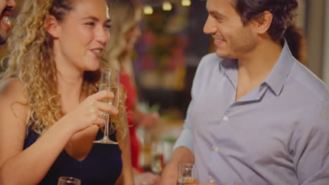 Multi-Cultural-Group-Of-Friends-Celebrating-Making-Toast-Enjoying-Party-Night-Out-In-Bar-Or-Club