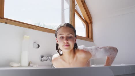 portrait of woman smiling in bathtub