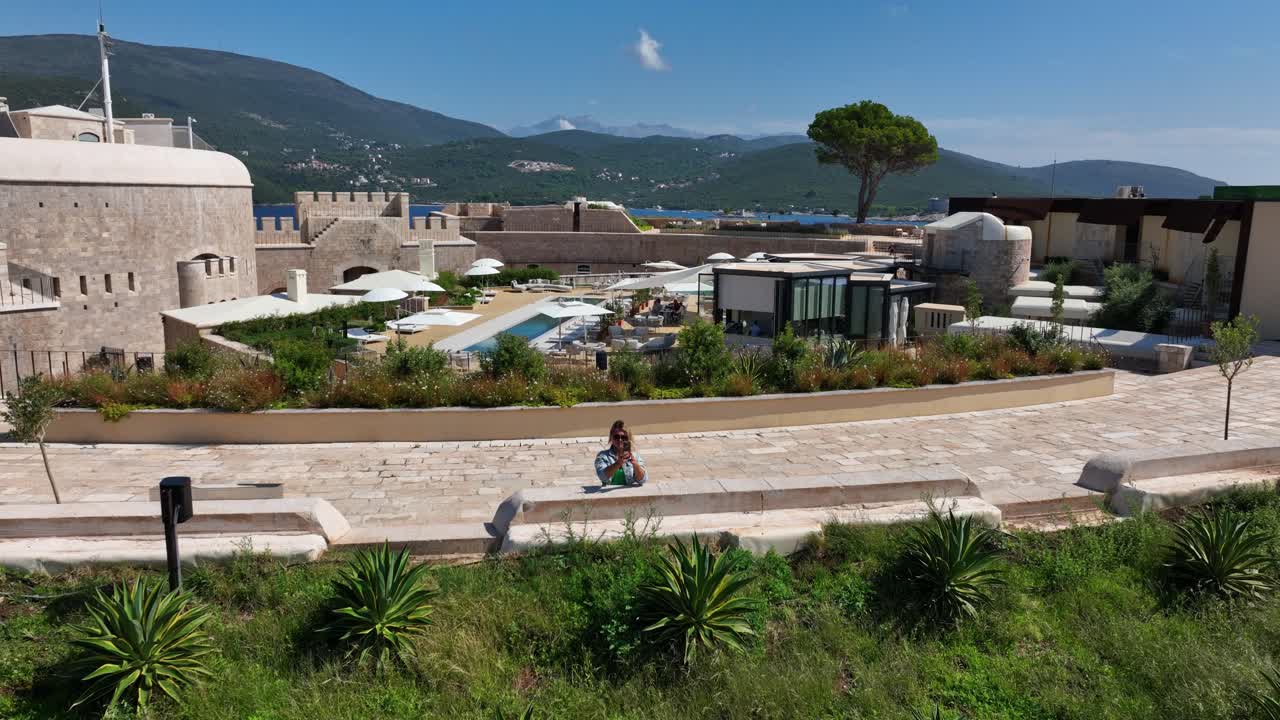 Woman Takes Pictures of View From the Mamula Island hotel, Aerial Shot