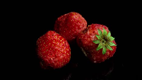 strawberry rots on a black background, time lapse, macro photography