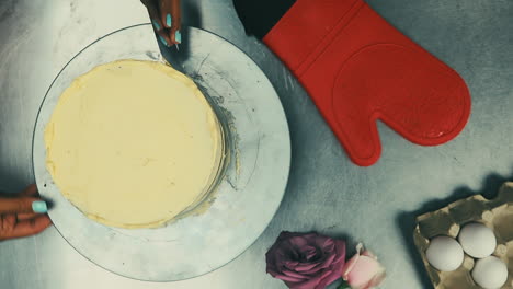 chef finishing vanilla cake slowmotion closeup