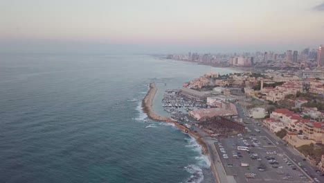 bird's eye view of the coastline of jaffa and tel aviv showing gray pink colors of the sky