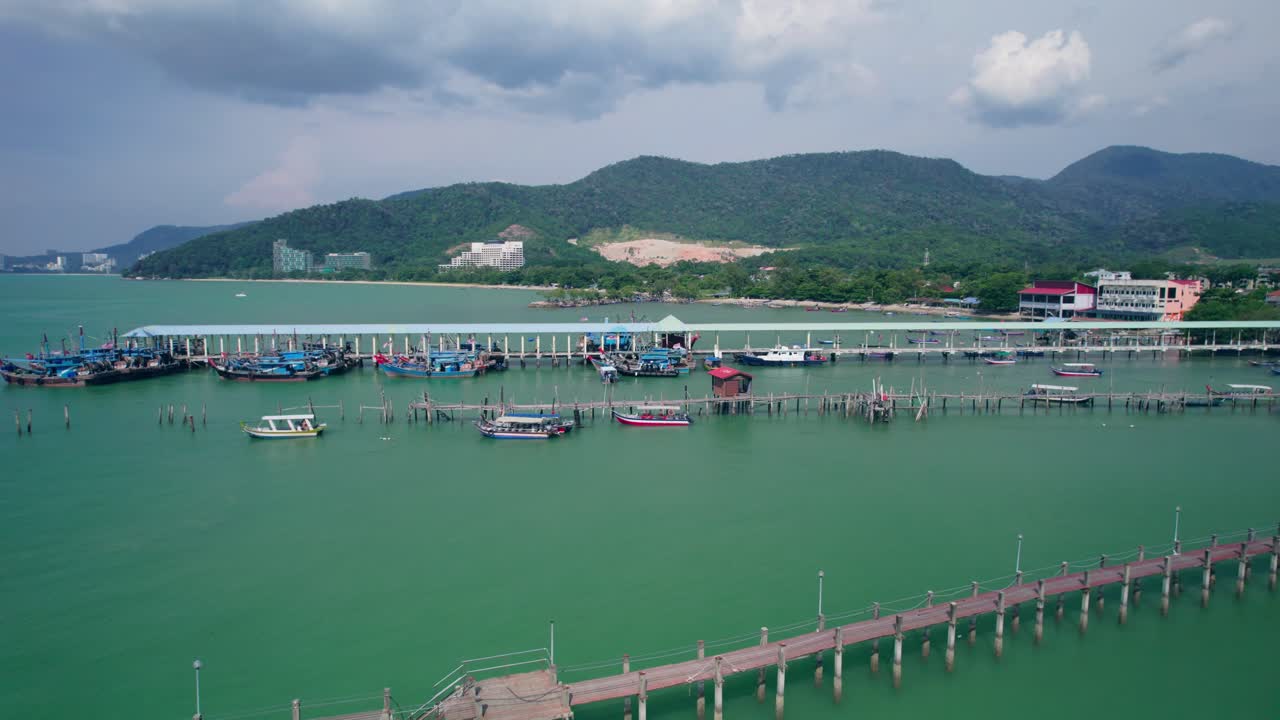Scenic aerial footage of a jetty stretching out over the water in a remote Malaysian setting
