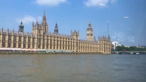 boat view of the iconic palace of westminster on a bright day in london
