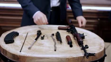 disassembled rifle parts on a wooden table