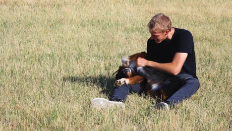 man playing with australian shepherd puppy canon r