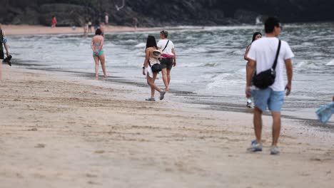 group walking along the beach in thailand