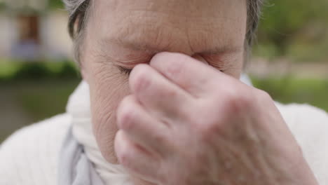 portrait-of-elderly-woman-looking-at-camera-feeling-tired-sleepy