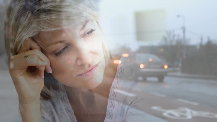 Digital animation of depressed elderly woman against city background 4K