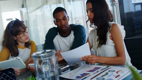 executives having discussion over document