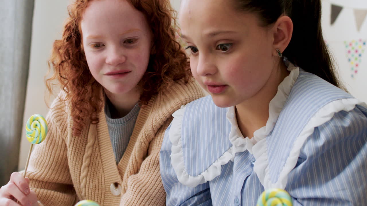 Girls licking lollipops