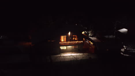 aerial drone shot of beautiful home prepared for the winter holidays with christmas lights