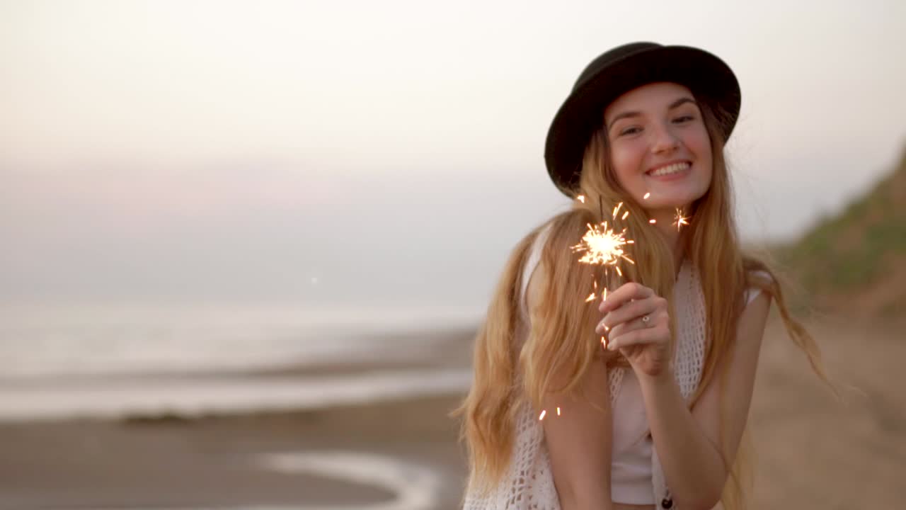 Happy Woman on the Beach with Sparkler