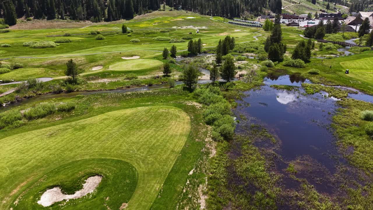 Olympic Valley CA USA, Drone Shot of Pedestrian Bridge, Walking Paths, Creek and Pond in Summer Season