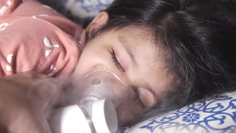 child receiving nebulizer treatment