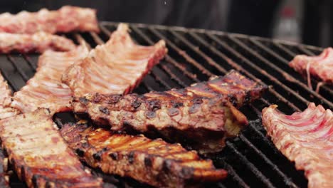 chef hand straightens grilled meat