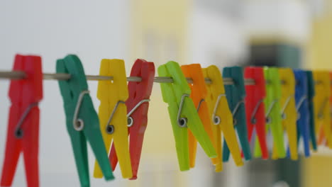 colorful clothespins hanging against house background