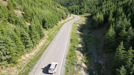 Road-surrounded-by-hills-and-lush-greenery