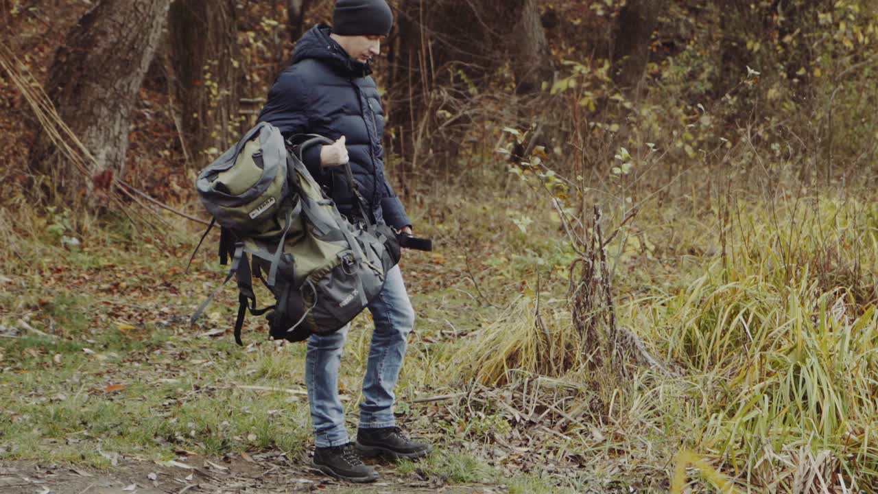 Man walking on nature. Hikers trekking in beautiful yellow autumn fields and forest