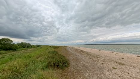 Cloudy-Sky-On-Windy-Day-At-Bradwell-Beach-In-Bradwell-on-Sea,-Southminster,-UK