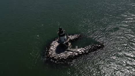 An-aerial-view-the-Orient-Point-lighthouse-off-the-east-end-of-Orient-Point,-NY-on-a-sunny-day