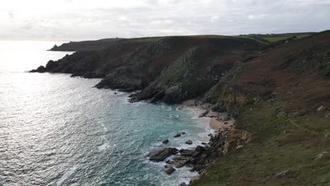 Aerial-forward-over-rocky-coast-of-Minack-in-Cornwall,-England