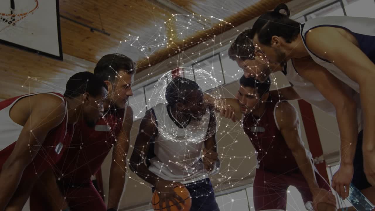 Five male sports team huddling leader dribbling ball planning soft net over group as view widening