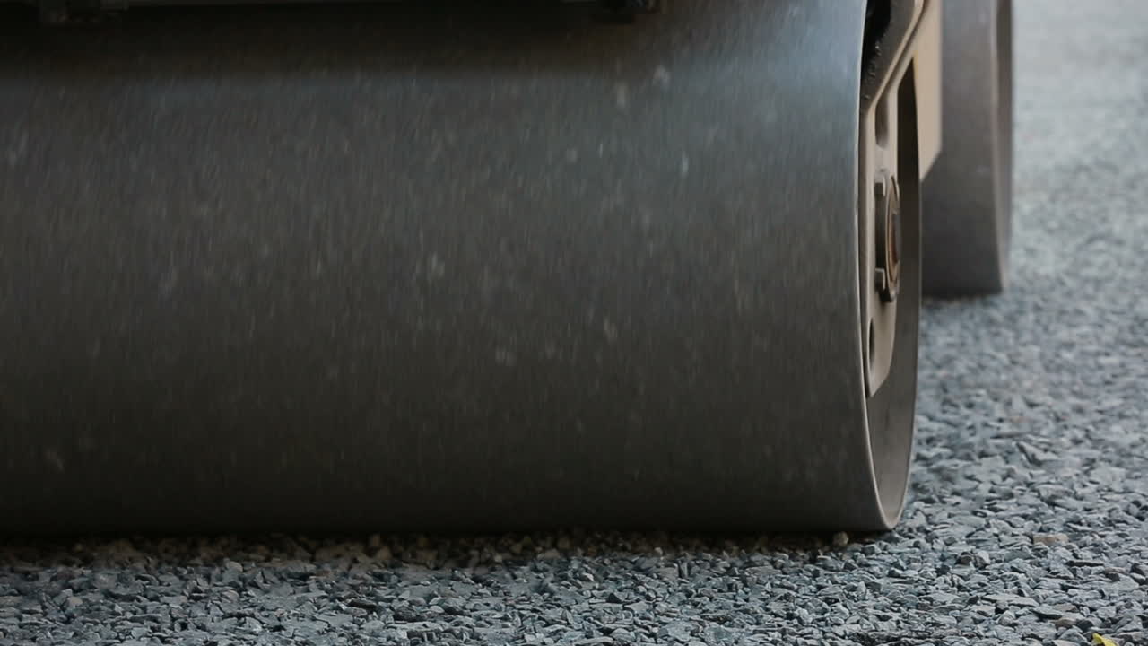 Road roller working on the new road construction site