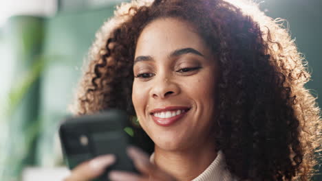 woman with curly hair using phone