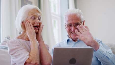 pareja de ancianos usando computadora portátil para conectarse con la familia para una videollamada
