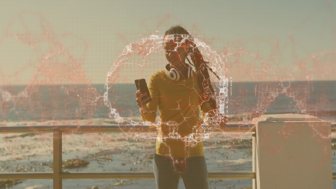 Person holding smartphone with digital network animation over ocean background