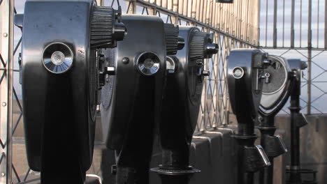 binoculars in the observation deck of the empire state building wait for people to view the city