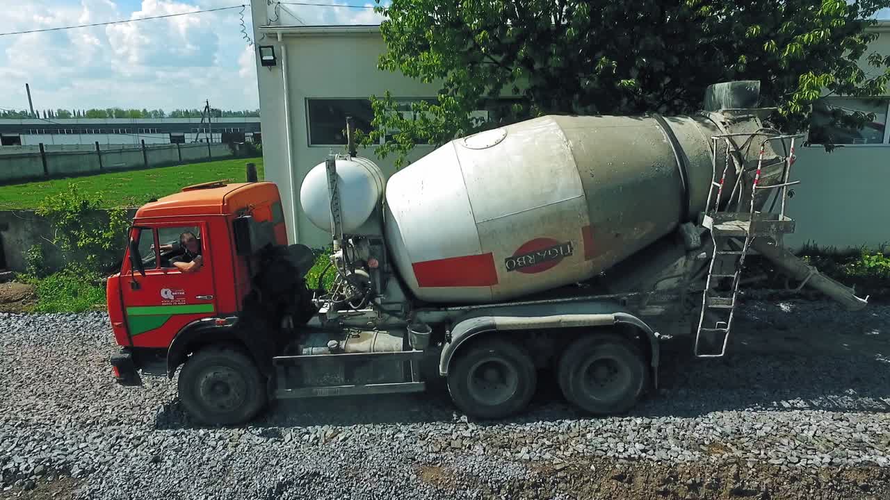 Concrete mixer truck from air. Heavy industrial machinery working at construction site