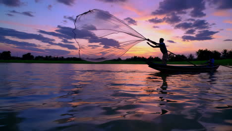 fisherman casting a net at sunset