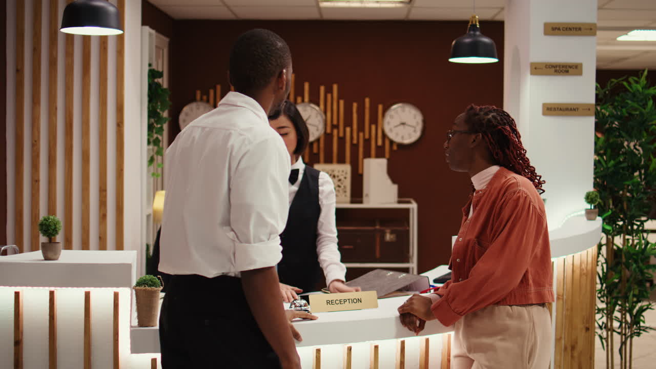 Receptionist handing contract on tablet
