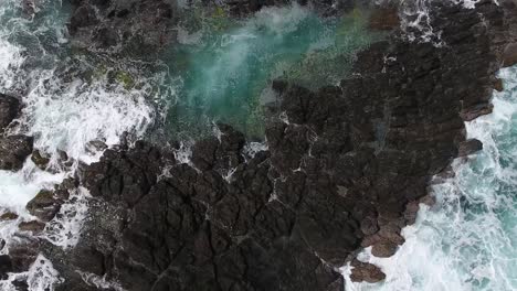 Aerial-drone-shot-zoom-out-over-peninsula-in-martinique.-fly-over-ocean