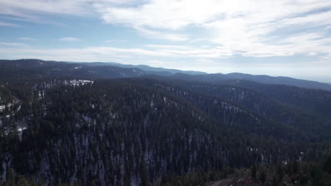 High-angle-drone-shot-reveals-a-snow-covered-mountain-valley-in-New-Mexico