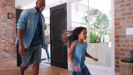 Mixed-race-couple-and-their-daughter-arriving-home