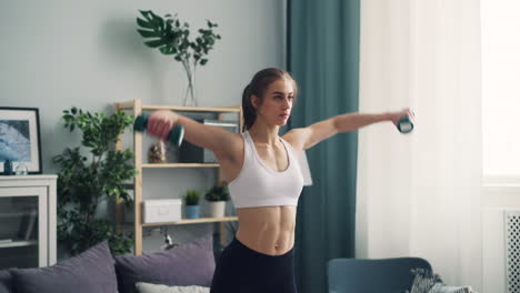 woman doing dumbbell arm workout at home