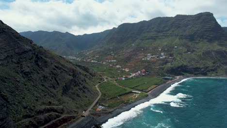 aerial view over the city of hermigua, surrounded by tall mountain peaks, la gomera island, spain