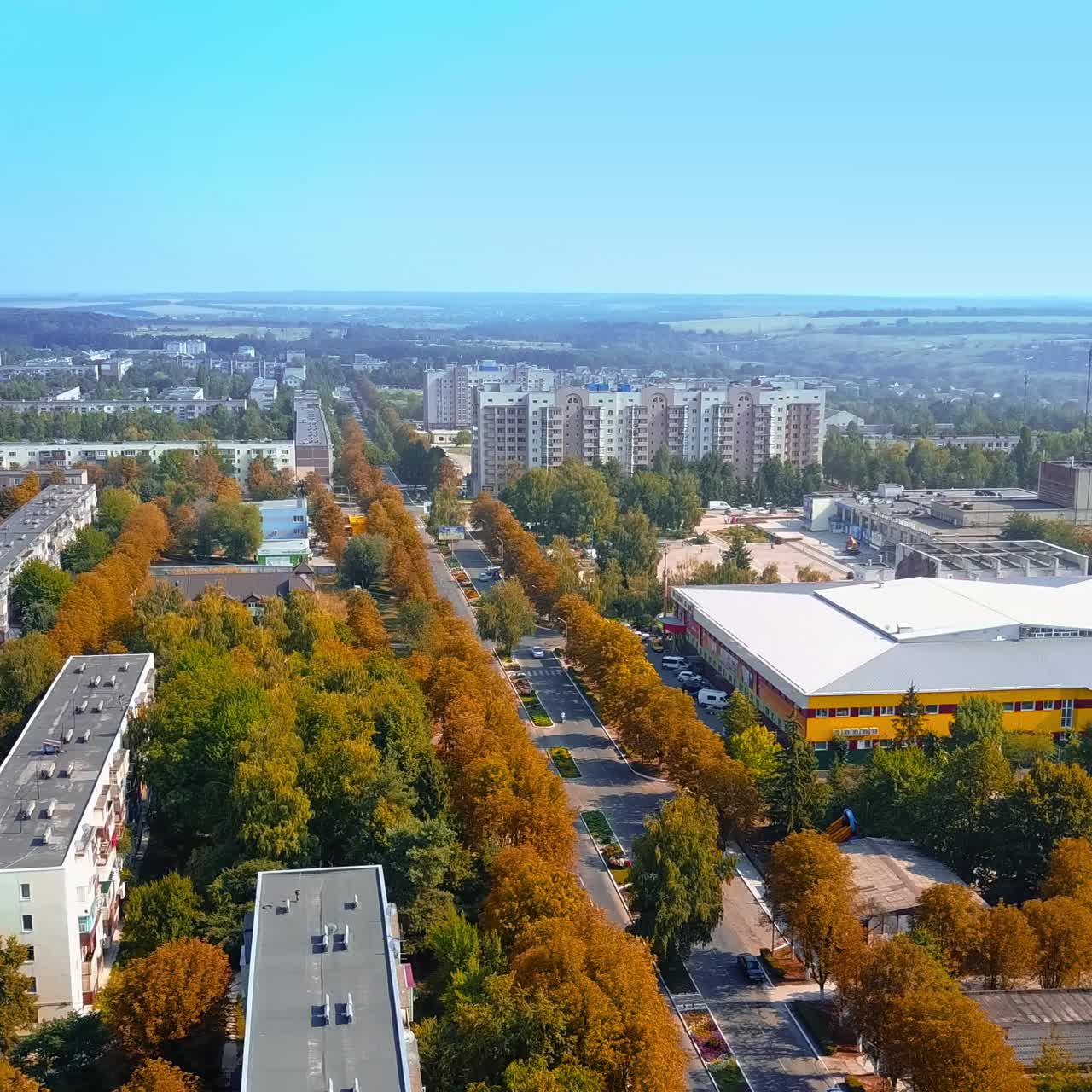 Urban landscape of a provincial city on sunny autumn day. Drone footage over the residential area at daytime