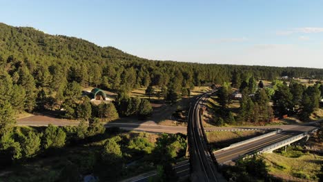 a reverse drone shot over railroad trestles in a rural colorado town